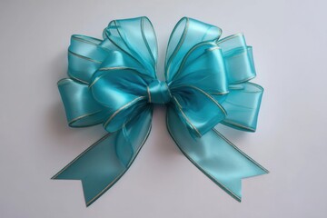 Poster - Turquoise Bow with Gold Trim on White Background Overhead Studio Shot Celebration Gift Wrap Decoration