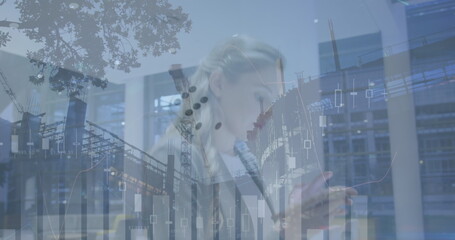 Poster - Image of financial data over caucasian businesswoman using smartphone and construction site
