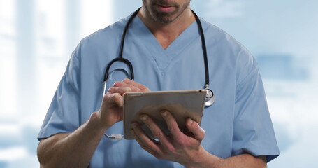 Poster - Image of caucasian male doctor using tablet over hospital