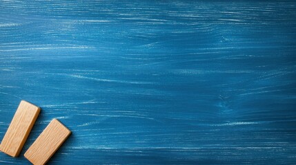 Poster - Two wooden blocks are positioned on blue wood surface