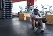 © Wavebreak Media - Mid adult African American man doing exercise on mat in gym with medicine ball, copy space
