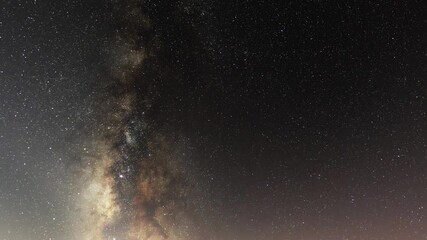 Wall Mural - beautiful night sky time lapse with milky way galaxy on dark sky. starry night background.