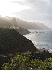 white village under the triangular rock roque de las animas on green shore of northern tenerife