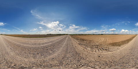 Wall Mural - hdri 360 panorama view on gravel road among fields with clouds in sky in equirectangular full seamle