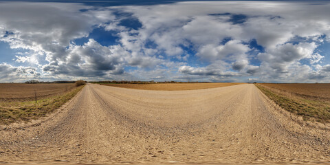 Wall Mural - hdri 360 panorama view on gravel road among fields with clouds in sky in equirectangular full seamle