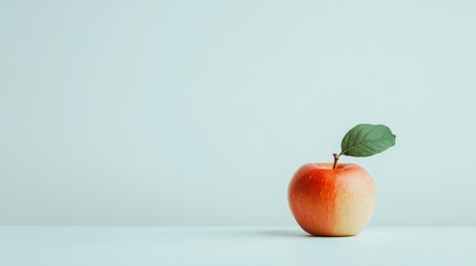 Poster - Single red apple with leaf on light blue background.