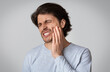 © Prostock-studio - Young man suffering from terrible strong teeth pain