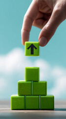 Poster - Green wooden blocks forming pyramid, hand placing top block with upward arrow, symbolizing growth, progress, and success