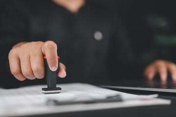 Poster - Businessman validates and manages business documents and agreements, approval stamp, signing a business contract approval of contract documents confirmation or warranty certificate,