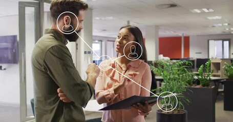 Poster - Two colleagues discussing documents in business office, showing floating network connection icons
