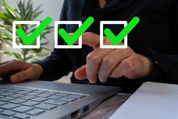 Poster - A businesswoman working on a laptop points to a green check mark icon in a square frame. Authorization concept.