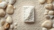 © elisa - White rectangular object on beige sand, surrounded by stones