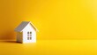 © Erisna Yolanda - Small white house model on a yellow background