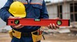 © Siasart Stock - Photo of Construction Worker Holding Red Level at Site