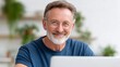 © Dzikrul Husnani - Smiling Older Man Wearing Glasses Working From Home