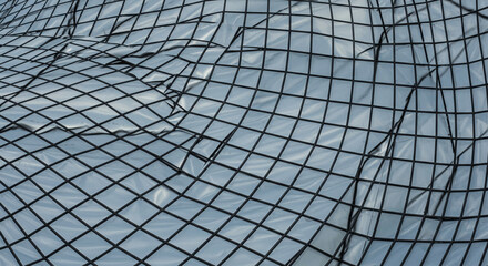 Abstract Fishing Net Texture Background Featuring Detailed Diamond-Shaped Mesh Pattern Creating Visual Depth and Interplay of Light and Shadow Showcasing Industrial Design
