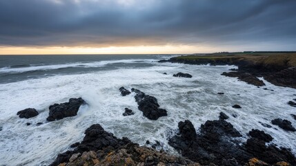 Poster - Towering waves collide with jagged rocks as sea spray fills the air, showcasing the ocean's raw power beneath an overcast sky during dusk