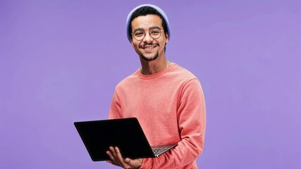 Aufkleber - Medium AI animated portrait of successful young male multiethnic designer, programmer or freelancer in casual outfit, with laptop, looking at camera with smile, posing in studio on purple background