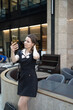 © night87 - A business lady takes a selfie in front of a restaurant