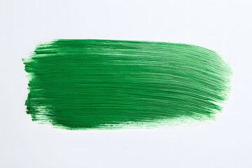 Wall Mural - Green paint brush stroke on on white background