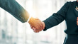 © peopleimages.com - Business people, handshake and meeting with greeting for partnership, b2b or deal together at office. Closeup, employees or colleagues shaking hands with lens flare for agreement, teamwork or job