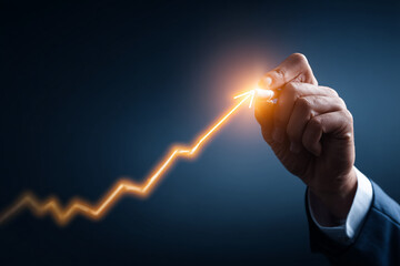 Poster - Hand draws luminous orange upward arrow on dark background, symbolizing growth, success, and positive progress in business