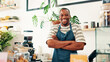 © peopleimages.com - Portrait, welcome and black man in restaurant, arms crossed and hospitality industry with friendly service. African person, business owner or entrepreneur with pride, coffee shop and professional