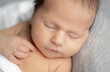 © tan4ikk - Newborn Baby Sleeping With A Smile In A Studio Photo