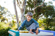 © Austockphoto - Portrait of happy young boy from on top of climbing castle in garden