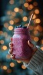 © homeganko - Vibrant Berry Smoothie in Glass Jar Held With Festive Background