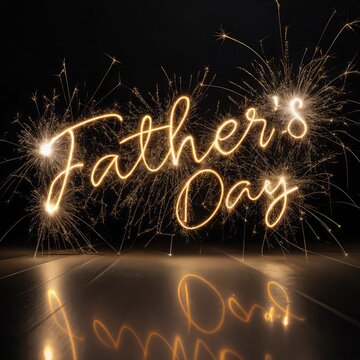 Fathers Day written in glowing golden sparkler light, cursive handwriting style, on a black background