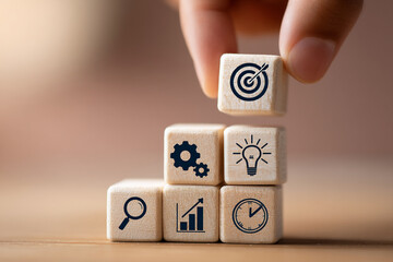 Poster - Wooden cubes with business iconsâ€”target, gears, lightbulb, magnifier, graph, clockâ€”stacked, symbolizing strategic planning and goal achievement.  Showcase for business concepts