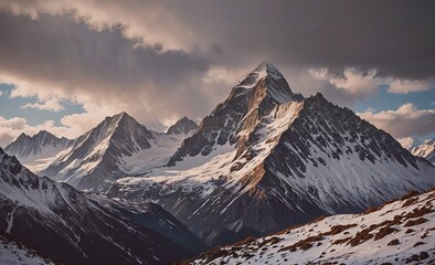 Fototapete - The mountains are covered in snow and the sky is cloudy. The mountains are tall and majestic, and the clouds add a sense of depth and drama to the scene
