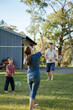 © Austockphoto - Family playing badminton in the backyard
