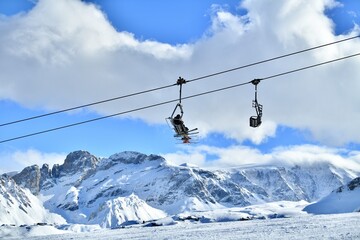 Fototapete - Ski lifts and skiers on the slopes Courchevel ski resort by winter