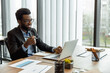 © zinkevych - African american businessman having a video call and looking excited