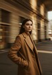 © JARVIS X - Stylish Woman in Brown Coat Walking in City Architecture. Elegant Fashion Portrait.