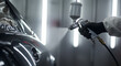 © abu - Close Up of Painter Spraying Silver Car Auto Body in Garage with Protective Suit