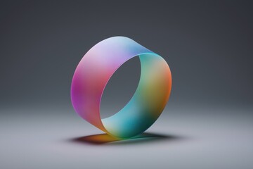 Poster - A colorful, rainbow-colored ring is displayed on a gray background. The ring is made of a translucent material, which gives it a unique and artistic appearance. The colors of the ring are vibrant