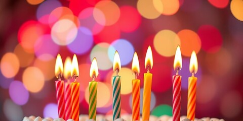 Wall Mural - Vibrant birthday candles glow brightly against a bokeh backdrop, festive lights adding to the celebratory mood, abstract, illumination