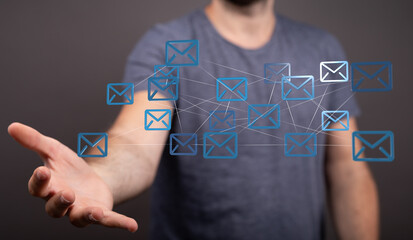 Fototapete - Man's hand displays a network of interconnected email icons, symbolizing global communication and digital connectivity.