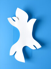 machine-cut paper shape with folds or flaps on blue paper
