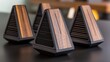 © Серг Нечаев - A trio of triangular wooden speaker devices with black speaker grills.
