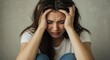 © Bang - Emotional woman sitting on the floor, holding her head in despair, indoors