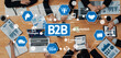 © InfiniteFlow - A dynamic business meeting focused on B2B strategies, featuring diverse professionals collaborating over laptops, charts, and innovative digital icons for modern commerce solutions. Amity