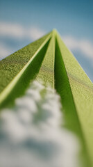 Poster - Close-up of textured green surface, forming a sharp point against a blurred sky, showcasing a modern, abstract design ideal for a minimalist concept