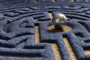 Poster - textured blue maze with golden path, featuring a silver sphere at a decision point, symbolizing prob
