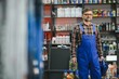 © Serhii - Salesman holding motor oil in auto parts store