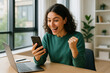 © Midea  - Woman working at desk with laptop and phone.