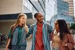 © Drazen - Multiracial group of students walking through campus.